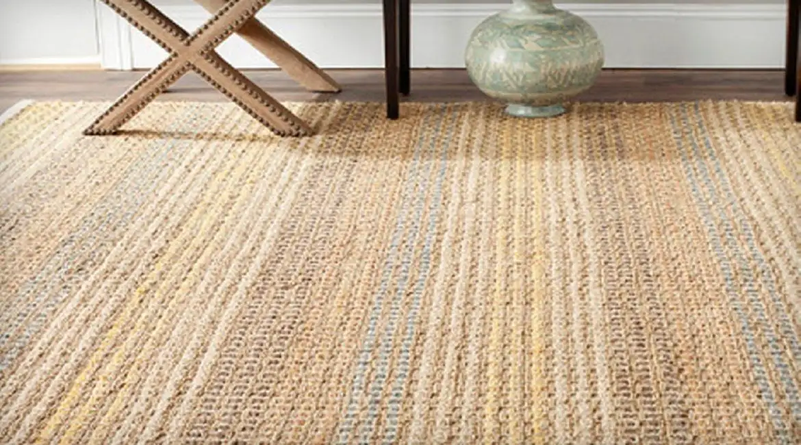 Natural jute carpet with a textured weave, perfect for a cozy living room.